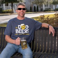 Man sitting on a bench holding a mug of beer, wearing a t-shirt with humorous text.