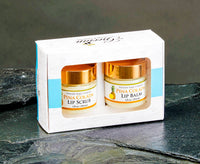 Pina Colada lip scrub and balm set in packaging on a dark surface