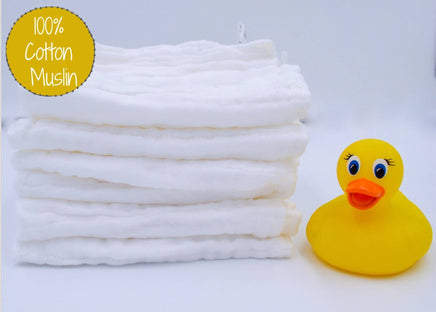 Stack of white cotton muslin with a yellow rubber duck on a light gray background