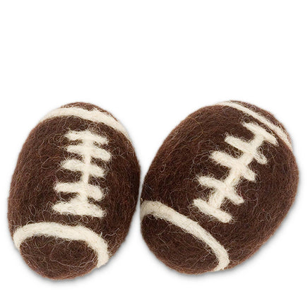 Two brown felted football-shaped cat toys with white stitching. handmade in nepal