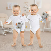 Two babies in white onesies holding gray elephant toys on a white background