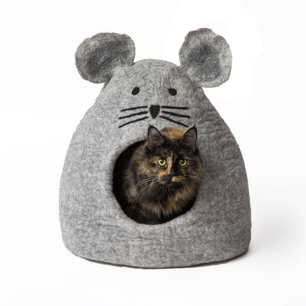 Cat inside a gray mouse-shaped pet bed on a white background