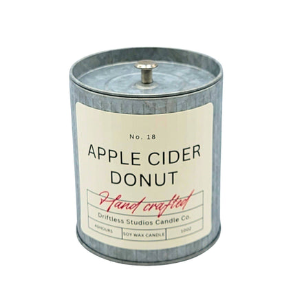 Candle with 'Apple Cider Donut' label on a white background
