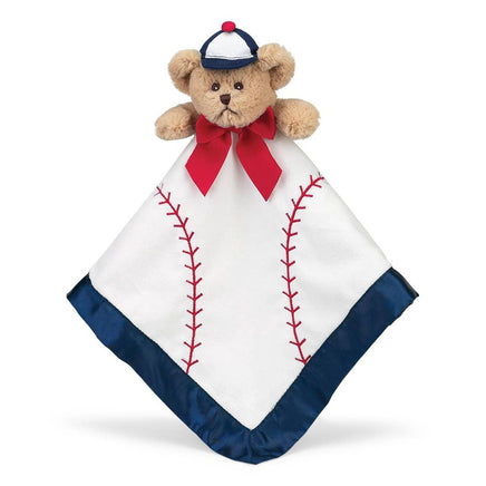 Teddy bear with a baseball-themed blanket on a white background