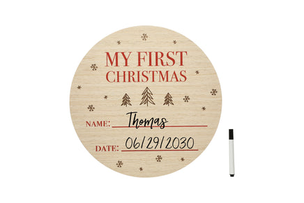 Round wooden plaque with 'My First Christmas' text and space for name and date on a white background.