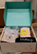 Open box containing makeup items with a visible brand name on the lid.