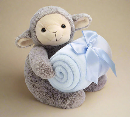 cute beige baby lamb holding a blue baby blanket that is tied with a ribbon
