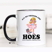 Mug with graphic design and text on a white background. funny saying on the front. All my friends are hoes. and in smaller print "hones, optimistic, empathetic soles" great friend gift. 