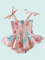 Baby outfit with pink top and ruffled bloomers featuring colorful butterfly designs on a white background.