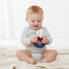 Baseball-shaped toy with a red bow and 'Lil' Slugger' text on a white background