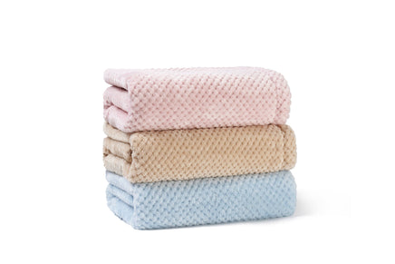 Stack of three folded towels in pink, beige, and blue on a white background