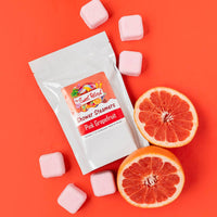 Pink grapefruit shower steamers with packaging on a red background