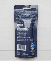 Dog treat package with text and branding on a beige surface