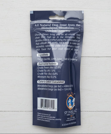 Dog treat package with text and branding on a beige surface
