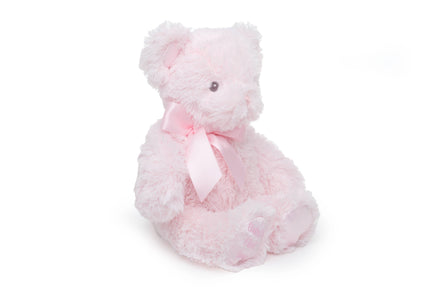 Pink plush bear with a bow on a white background