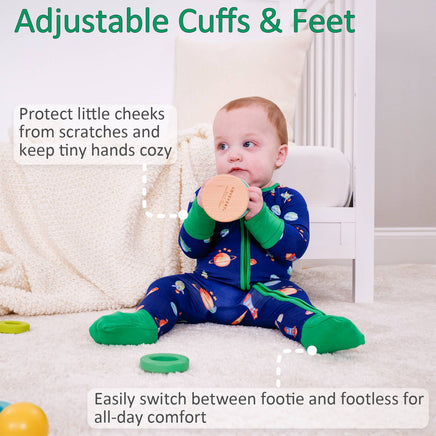 Baby wearing a colorful onesie with adjustable cuffs and feet, sitting on a carpeted floor.
