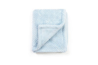 Folded light blue blanket on a white background