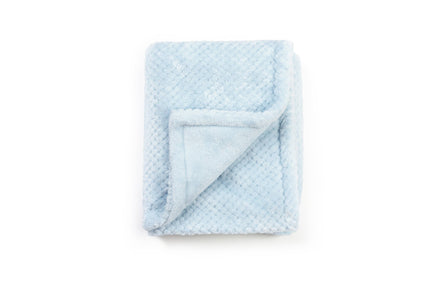 Folded light blue blanket on a white background