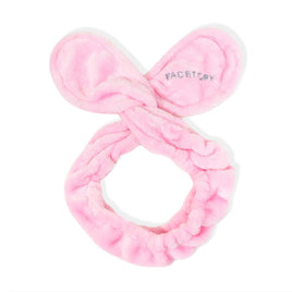 Pink bow-shaped makeup remover hairband with 'FACETORY' branding on a white background