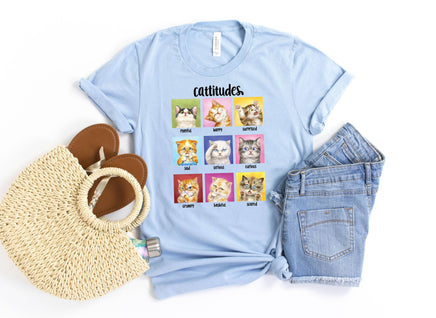 Light blue t-shirt with cat-themed design, shorts, and bag on a white background