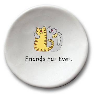 A round white ceramic dish or coaster featuring a cute cartoon illustration of two cat friends hugging, with the text 'Friends Fur Ever.' printed below in black.