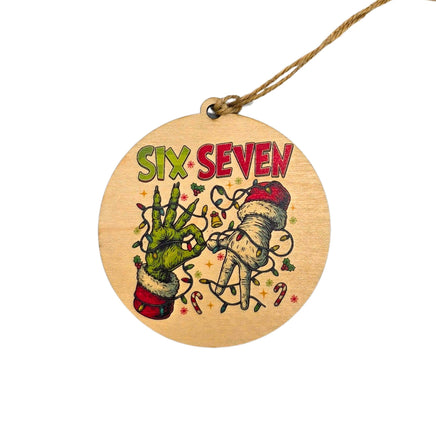 Round wooden ornament with 'Six Seven' text and artistic designs on a white background