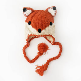 Knitted fox hat with a tassel on a white background