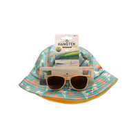 Child in a pool wearing sunglasses and a hat with other children in the background.