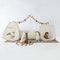 Children's play area with fabric playhouses, stuffed animals, and a banner on a white background