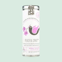 Tea canister labeled 'Peaceful Spirit' by Flying Bird Botanicals on a light green background