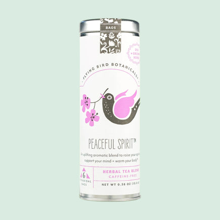 Tea canister labeled 'Peaceful Spirit' by Flying Bird Botanicals on a light green background