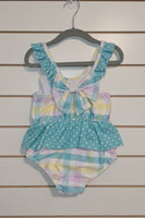 Pastel patterned swimsuit on a textured surface