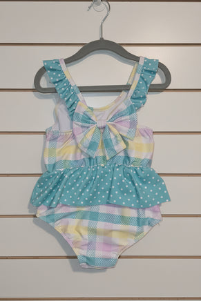 Pastel patterned swimsuit on a textured surface