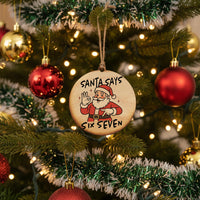 Wooden ornament with Santa Claus illustration and text 'Santa Says Six Seven' on a white background