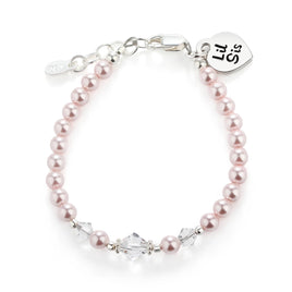 Pink pearl bracelet with clear crystal beads and 'Lil Sis' sterling silver heart tag on a white background