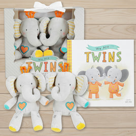 Set of plush elephant toys with a 'We Are Twins' book in packaging