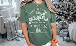 Person wearing a green t-shirt with a printed quote, sitting indoors.