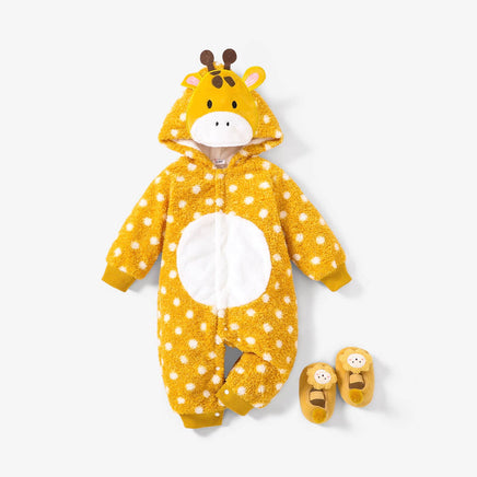 A baby wearing a yellow and black giraffe-patterned hooded jumpsuit with a snap-closure front and snug-fitting design, accompanied by a pair of booties.