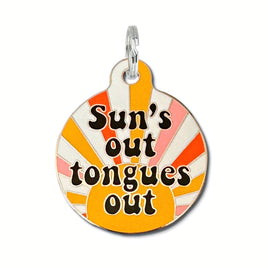 metal dog tag with scannable QR Code on the back. bright colors and says suns out tongues out